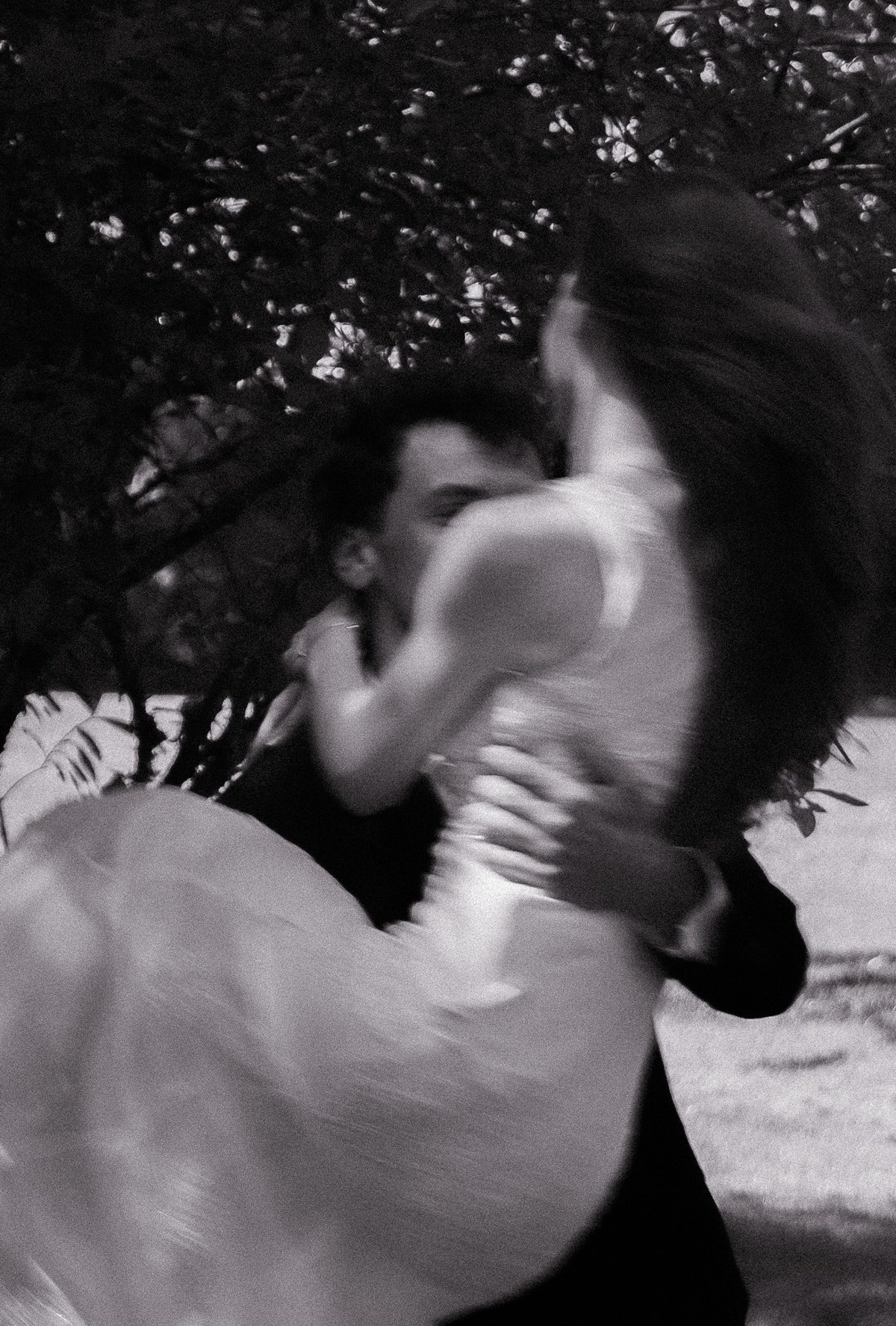 Bride and groom embracing in a soft black and white wedding photograph