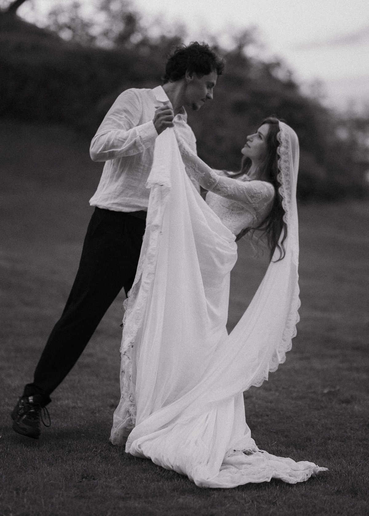 Bride and groom moving together in an editorial black and white portrait
