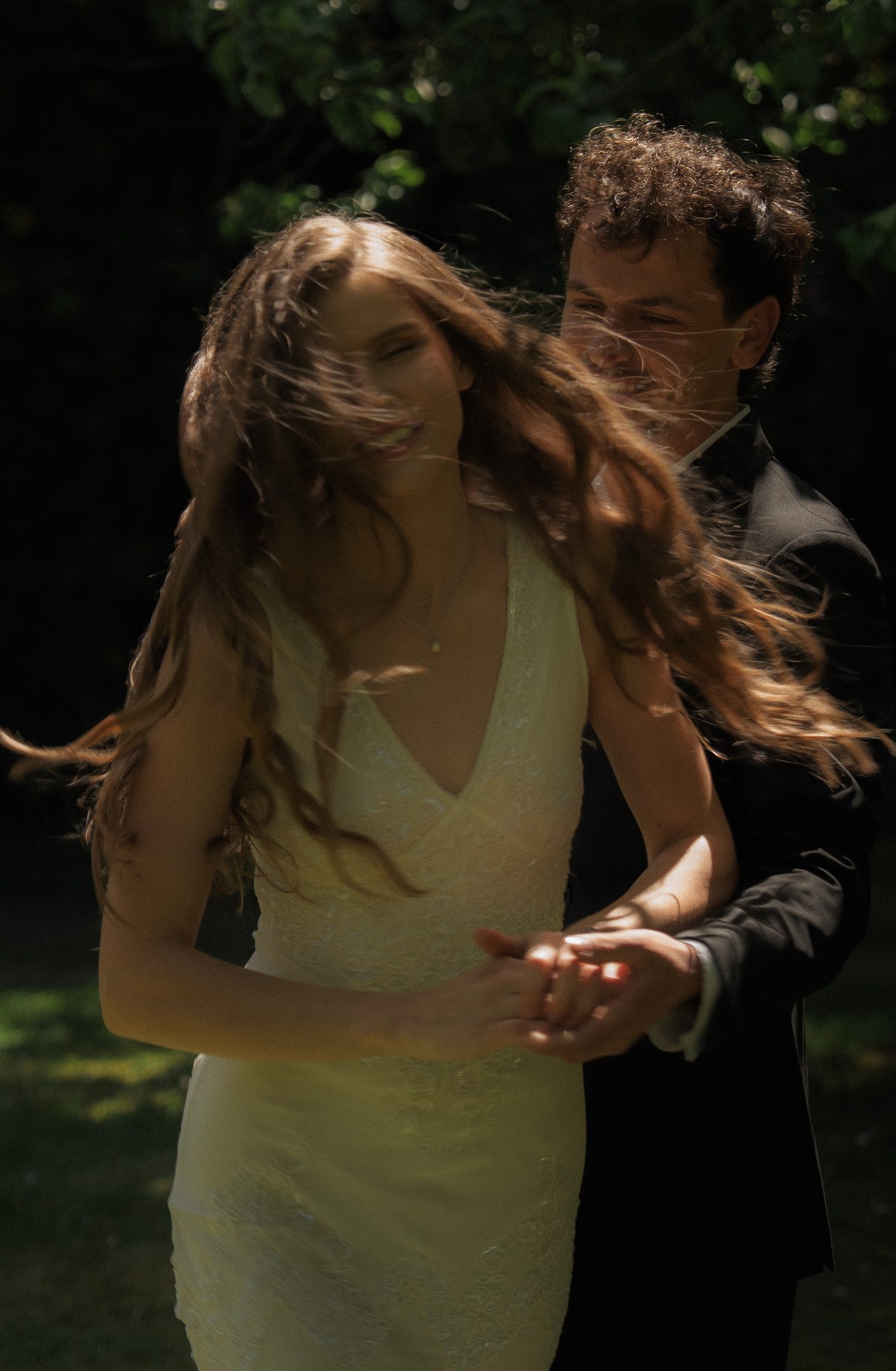 Bride and groom laughing together in candid movement