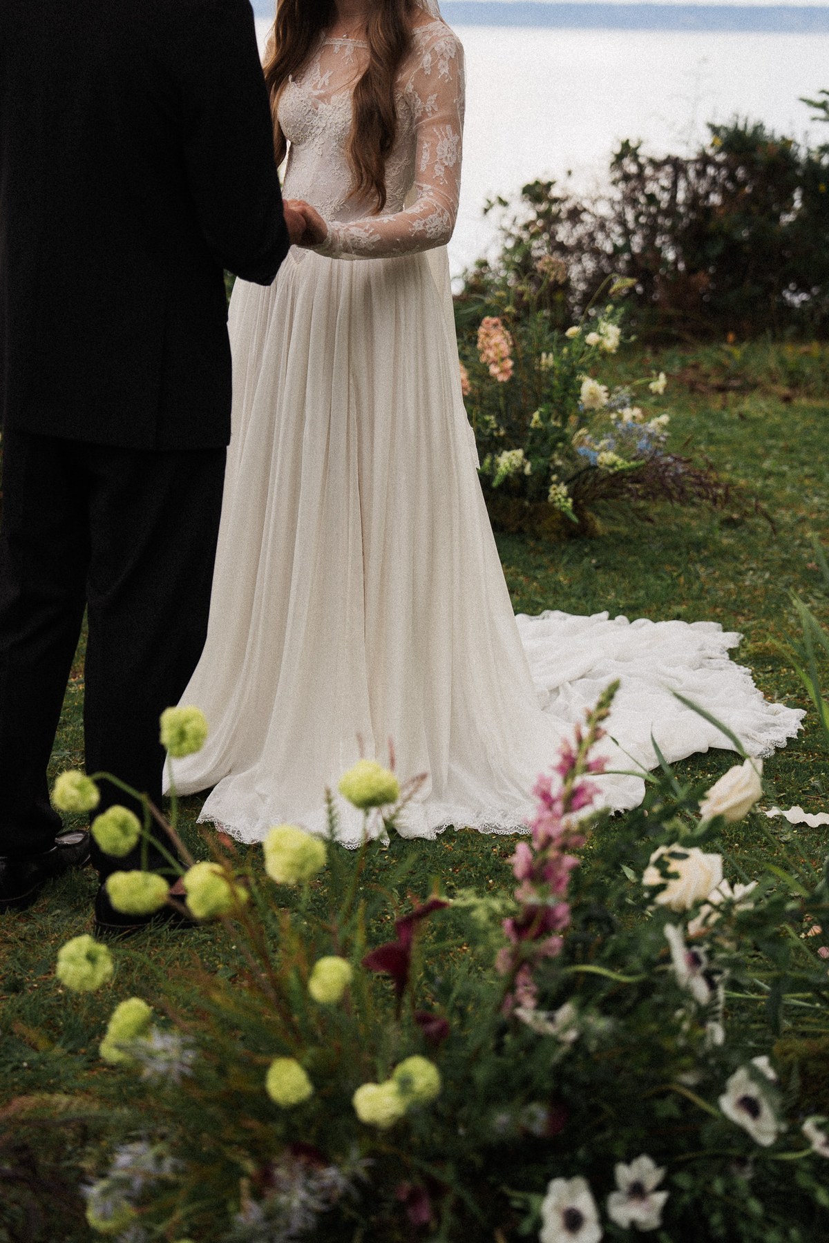 Wedding dress and floral details during an outdoor ceremony