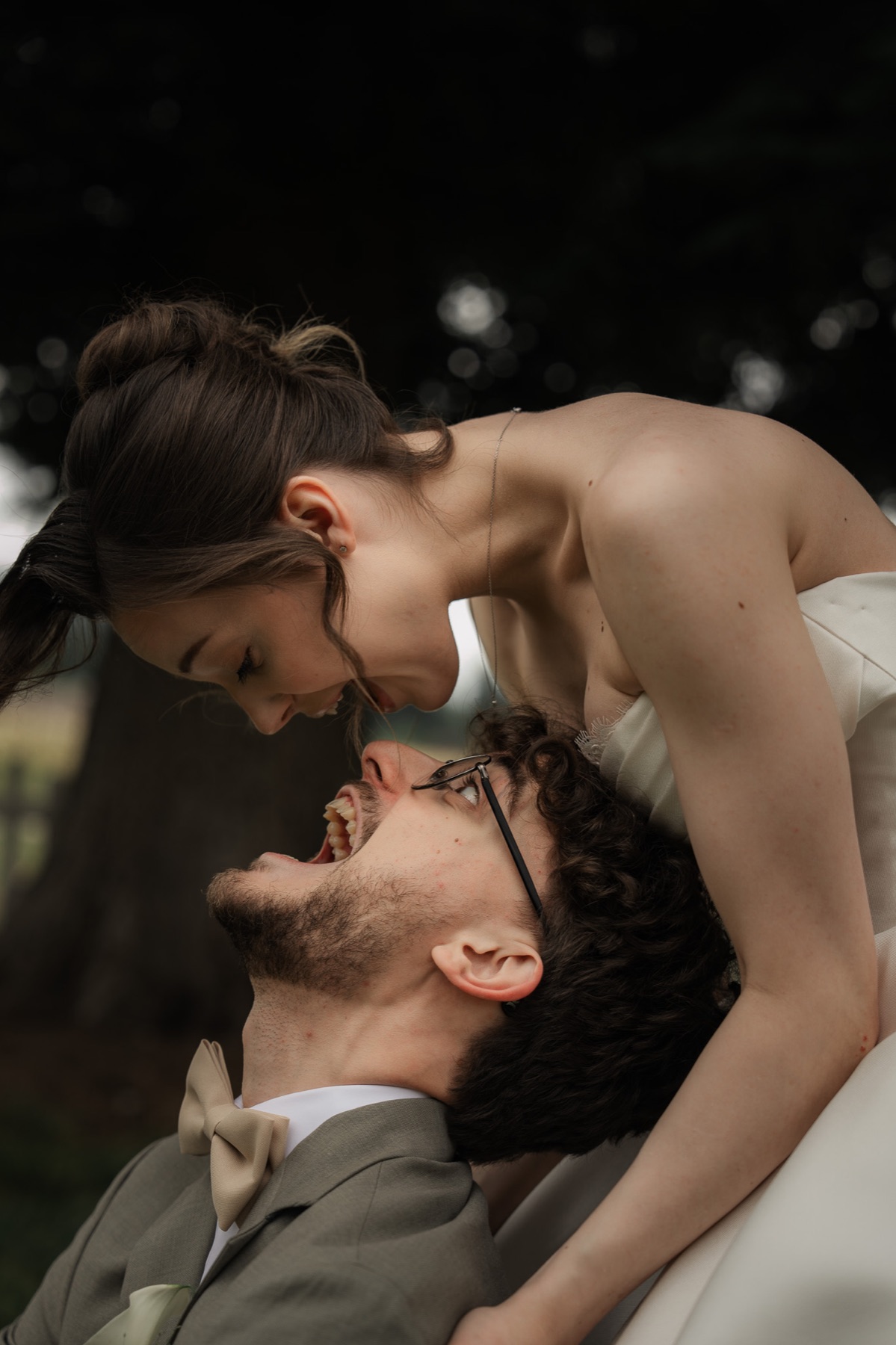 Wedding couple moving playfully together in a garden