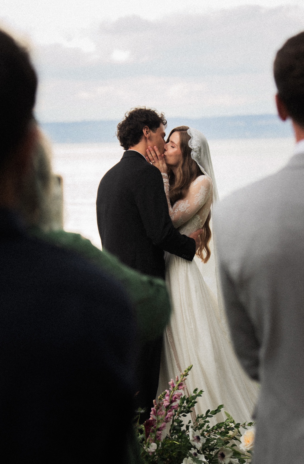 Wedding couple kissing during an outdoor ceremony