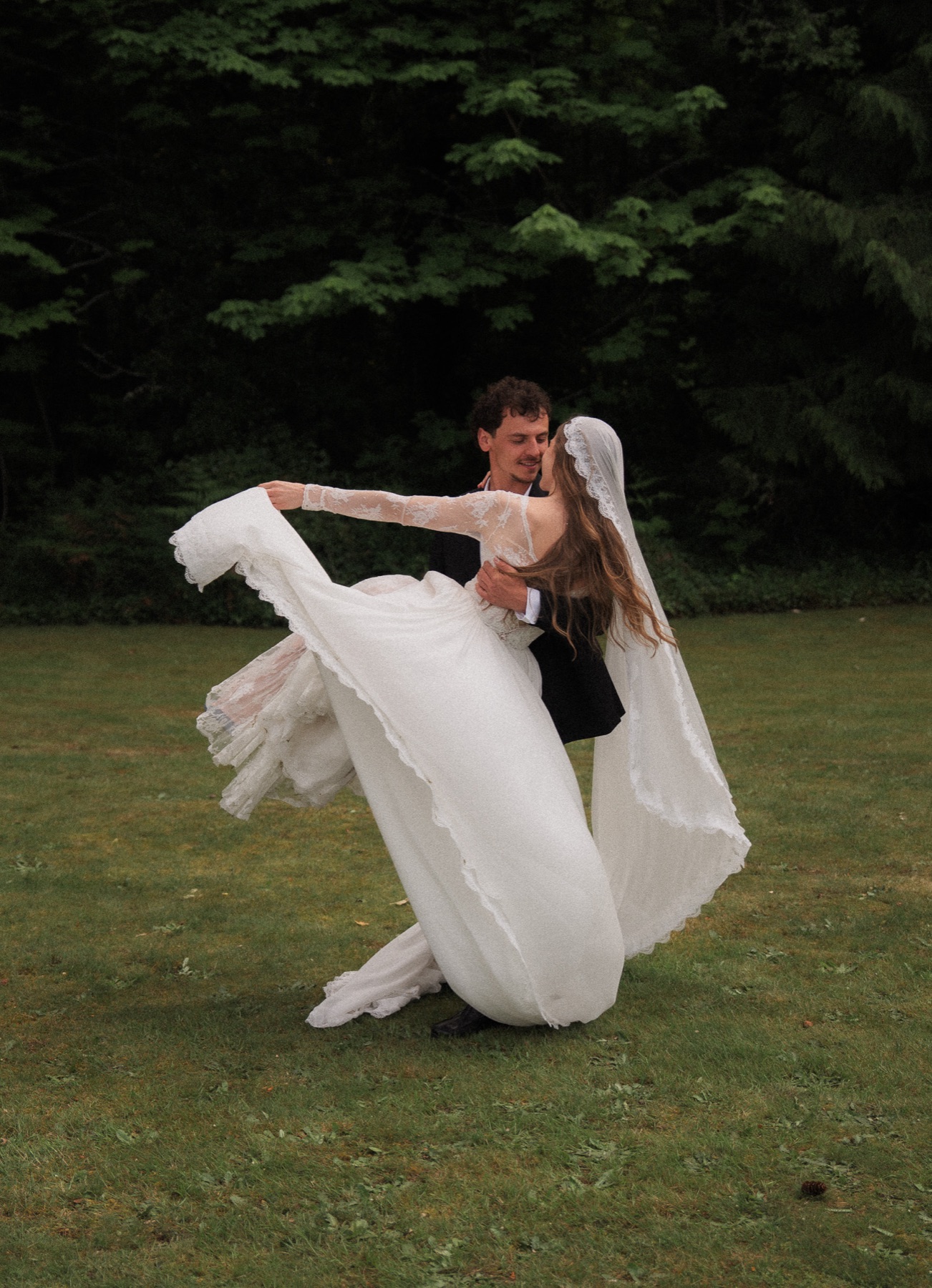 Wedding couple moving together on a lawn